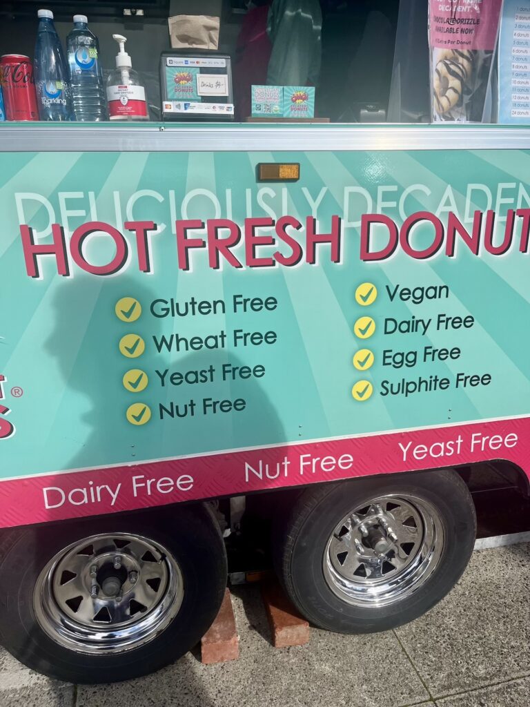 Looking up close at a gluten-free donut cart on black wheels